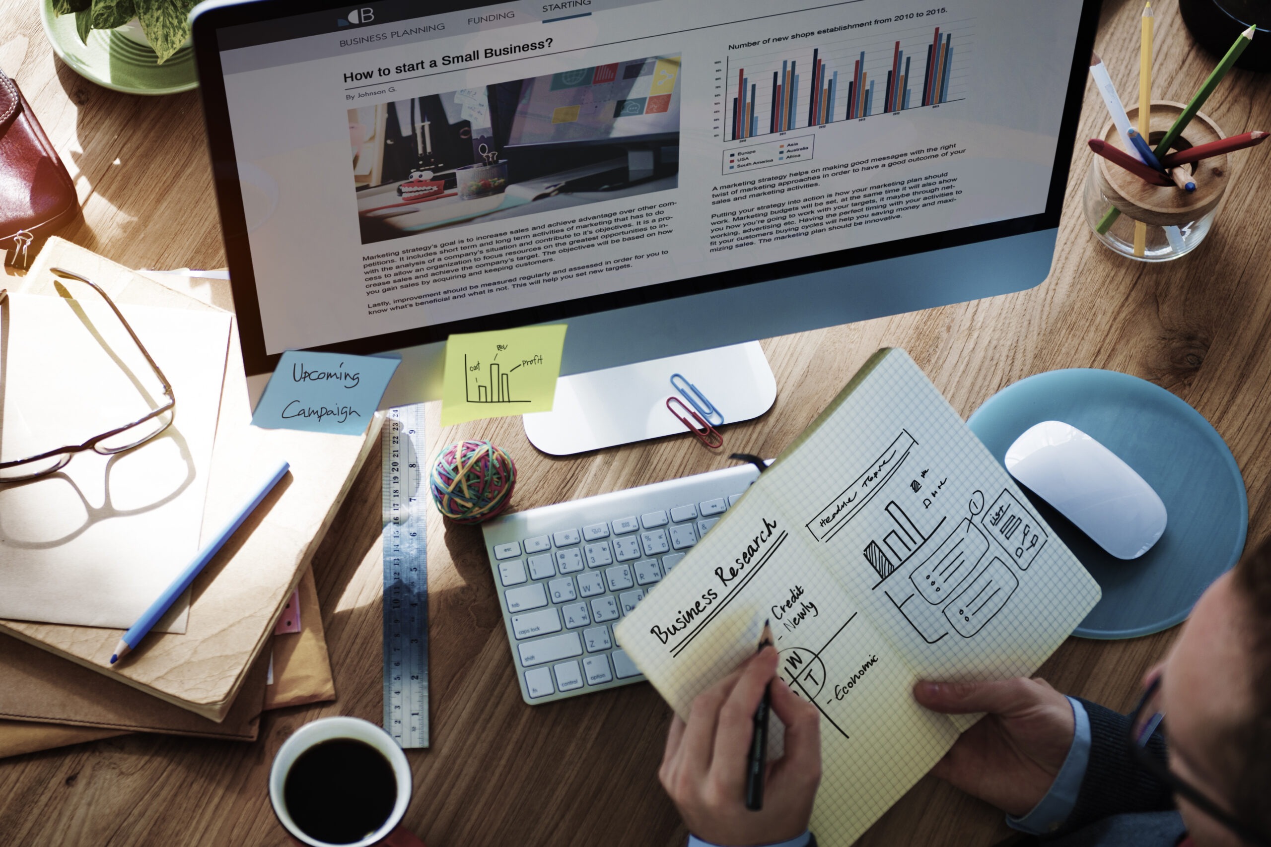 Person planning business website design at desk